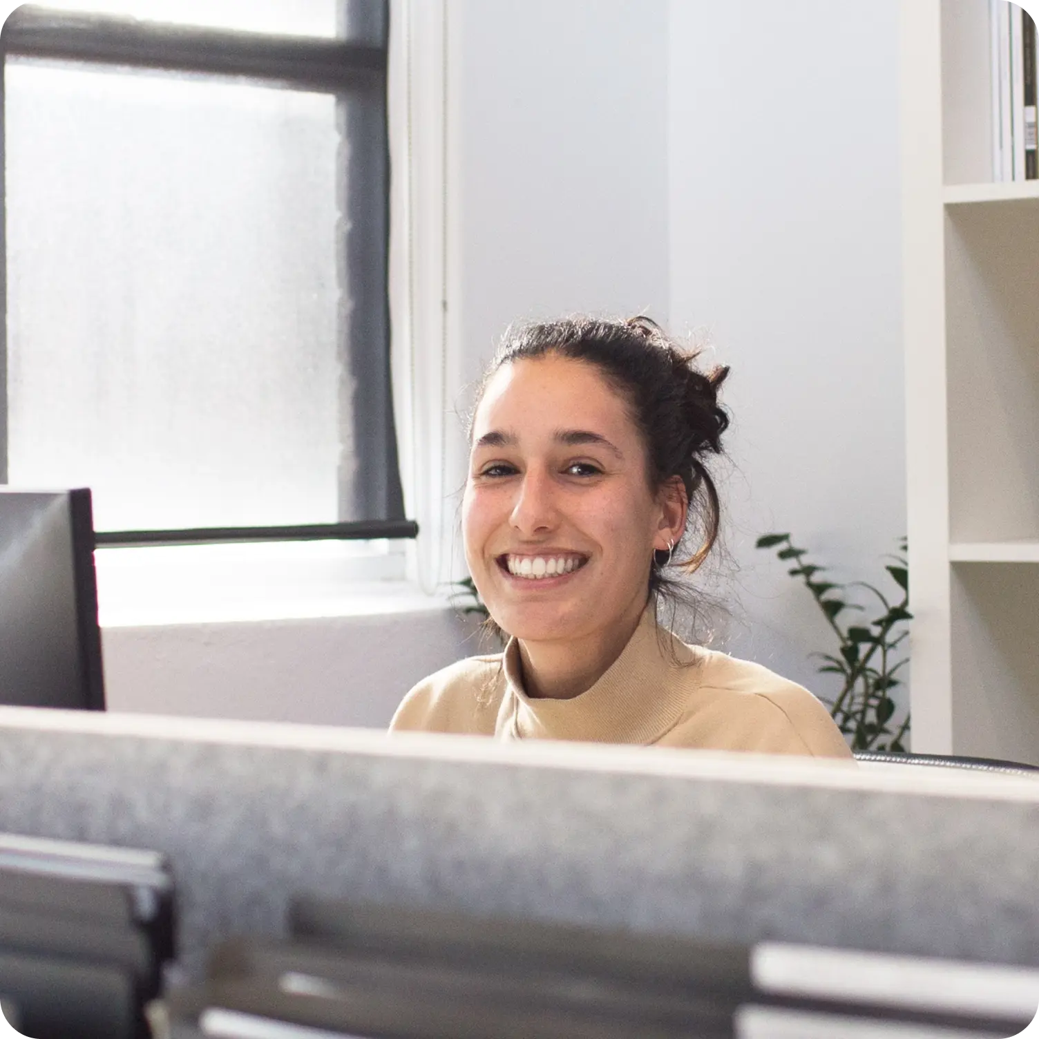 A woman behind a desk.